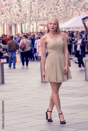 Beautiful blonde girl walking the streets of the city