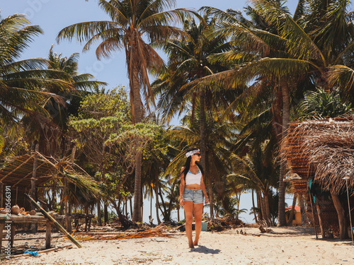 woman walking around into the palm tree jungle in Onok island in  Balabac in Philippines photo