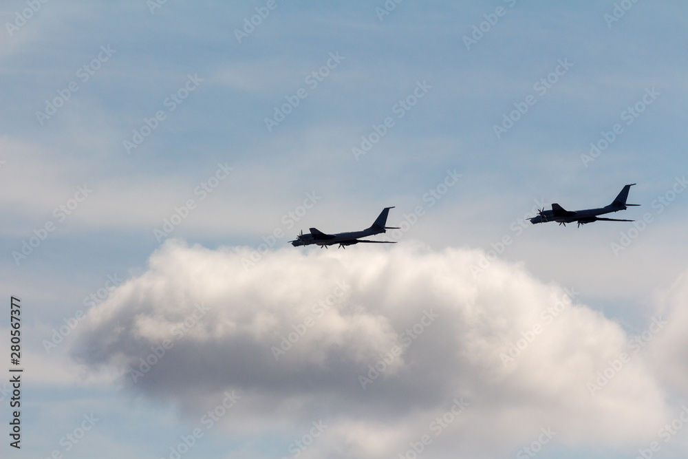 Black silhouettes flying Russian Tu-95 strategic bombers against the sky (NATO reporting name: Black silhouettes flying Russian Tu-95 strategic bombers against the sky (NATO reporting name:
