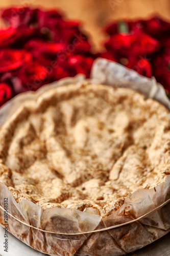 Portuguese traditional cake, sponge cake. on the wooden table with roses. photo