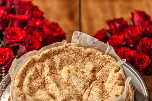 Portuguese traditional cake, sponge cake. on the wooden table with roses. photo
