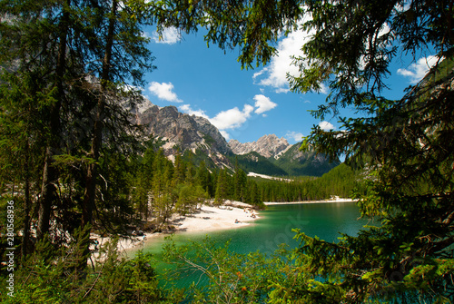 Fototapeta Naklejka Na Ścianę i Meble -  Turquoise water of the lake Lago di Braies, Pragser Wildsee surrounded by pine forest and mountains in the Prags Dolomites in South Tyrol, Italy, Europe