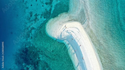 Top down view of tropical sandbar beach with turquoise water and white sand