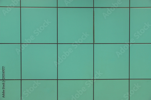 Green square tile background with black lines