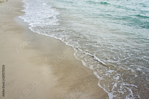 Sea wave on the clean sandy shore of the Black Sea