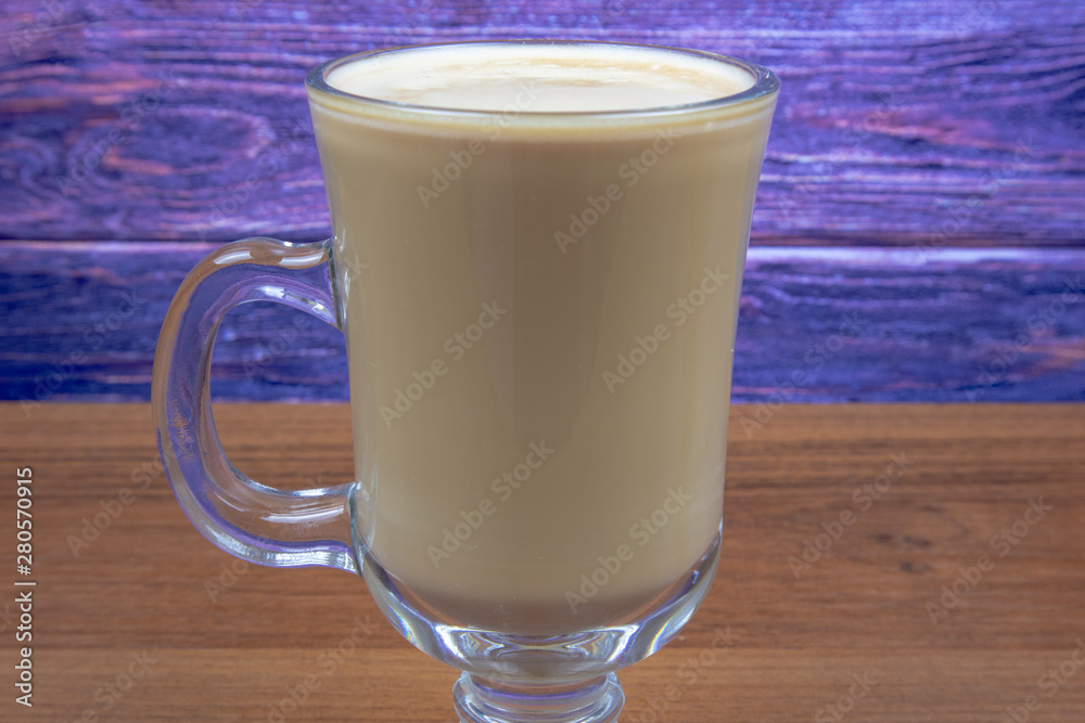 Latte coffee in a tall glass on a wooden table Latte coffee in a tall glass on a wooden table