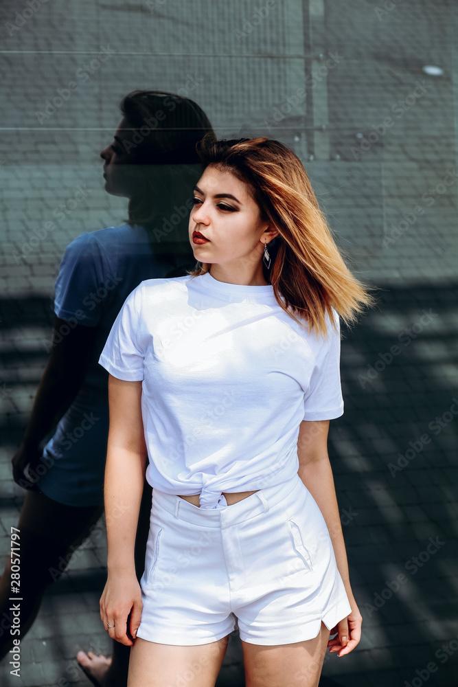 Stylish girl in white t-shirt and white shorts. Stylish girl in white t-shirt and white shorts.