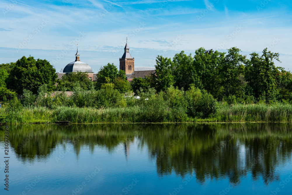 River Linge with reflection and church of Leerdam. The Netherlands