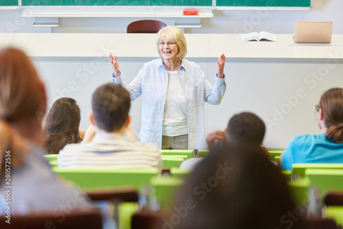 Woman as lecturer teaches students class