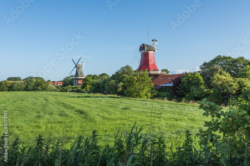 Blick auf die historischen Greetsieler Zwillingsmühlen, Ostfriesland, Deutschland  photo