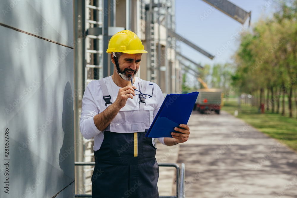 worker controlling grain load in factory worker controlling grain load in factory