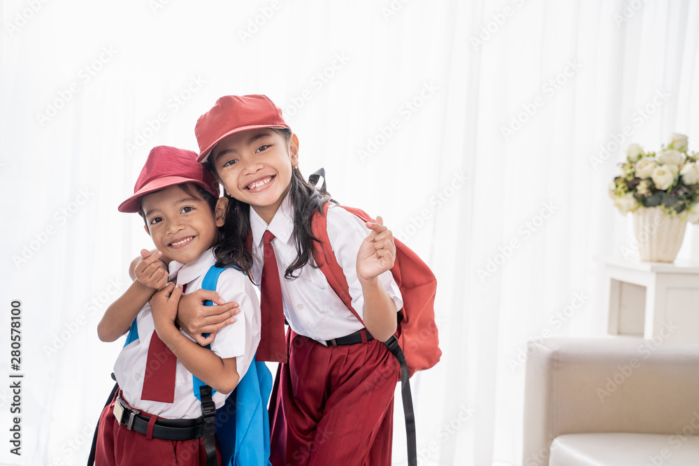 lovely two elementary student smiling to camera over white background lovely two elementary student smiling to camera over white background