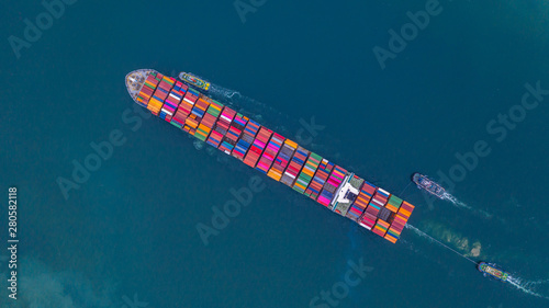 Container ship carrying container aerial view, Business import and export logistic and transportation of international by container ship in the open sea, with copy space.