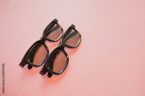3D cinema, glasses for cinema on a pink background.