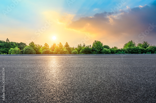 Asphalt highway and green forest with beautiful cloud landscape at sunset © ABCDstock