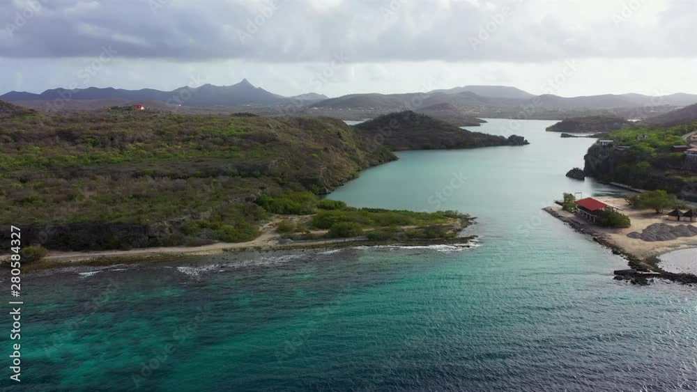 Aerial view of coast of Curaçao in the Caribbean Sea with turquoise water, cliff, beach and beautiful coral reef around the Sta. Martha Bay