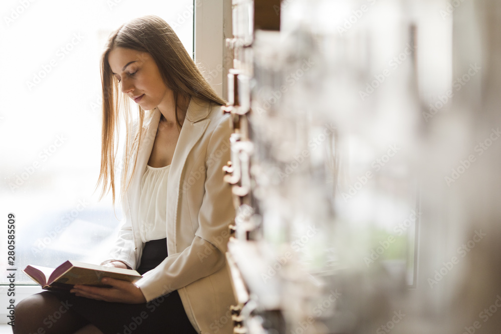 Back to school concept with woman studying in library Back to school concept with woman studying in library