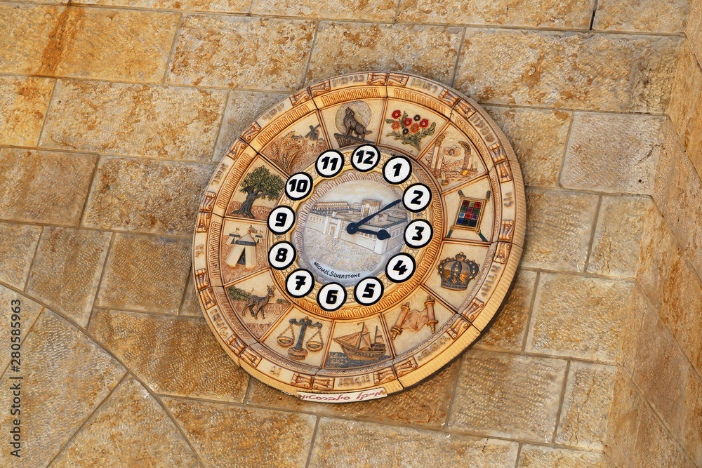 Old clock face shows time signs zodiac on western wall city Jerusalem