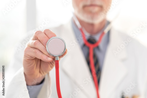 Male doctor holding stethoscope