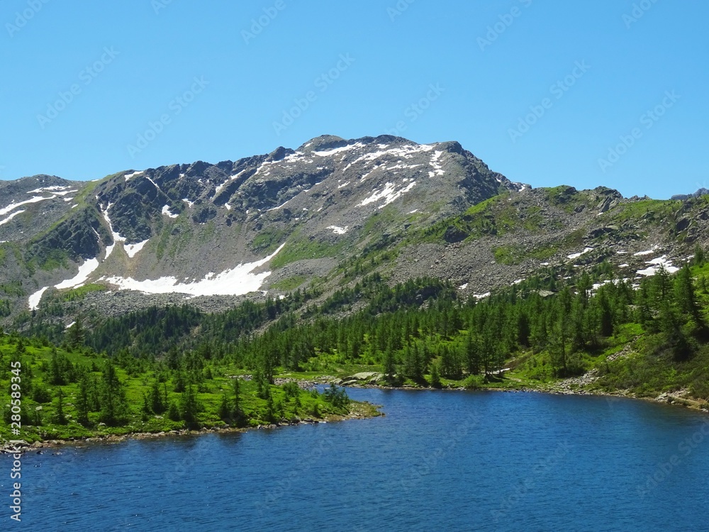 a lake in the Alps of Val Bognanco during a summer day, near the village of Domodossola, Italy - June 2019. a lake in the Alps of Val Bognanco during a summer day, near the village of Domodossola, Italy - June 2019.