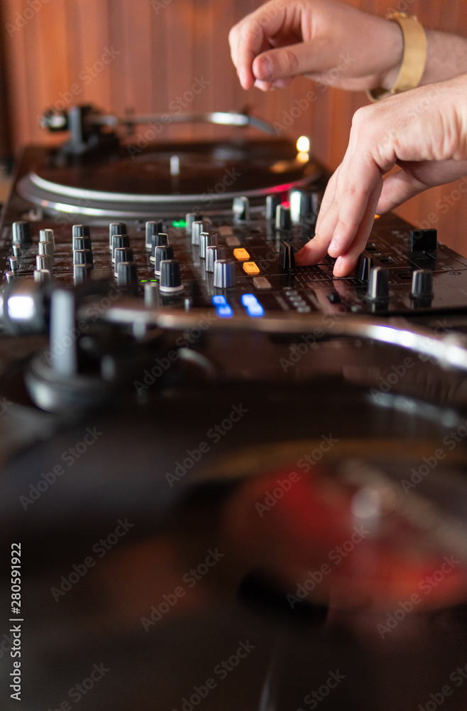 DJ playing on wooden booth at party DJ playing on wooden booth at party
