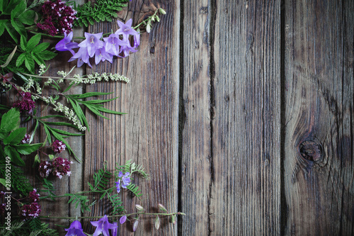 wildflowers on dark old wooden background