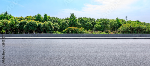 Asphalt highway and green forest with beautiful clouds landscape