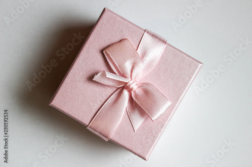 pink gift box with ribbon and bow isolated on white © Maria S