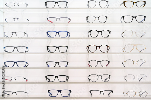 Stand with glasses in the store of optics  eye concept. Close-up many glasses on a stand.