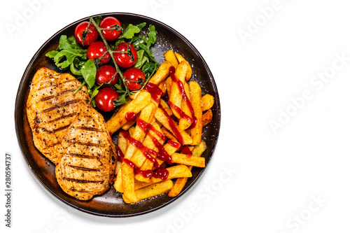 Grilled chicken fillet with french fries on white background