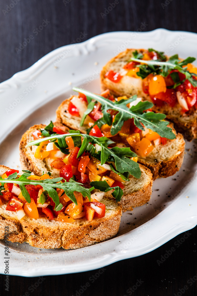 Bruschettas on plate on wooden background Bruschettas on plate on wooden background
