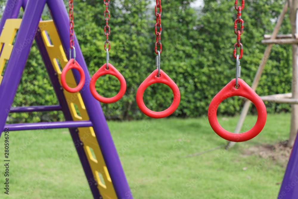 Red rings for children to hung on the playground. Player for children on the playground. Red rings for children to hung on the playground. Player for children on the playground.