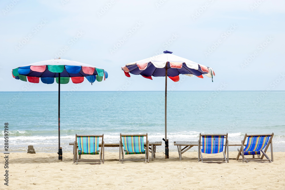 Beach chair on white sand with sea wave and sunny. Relaxing on the beach.