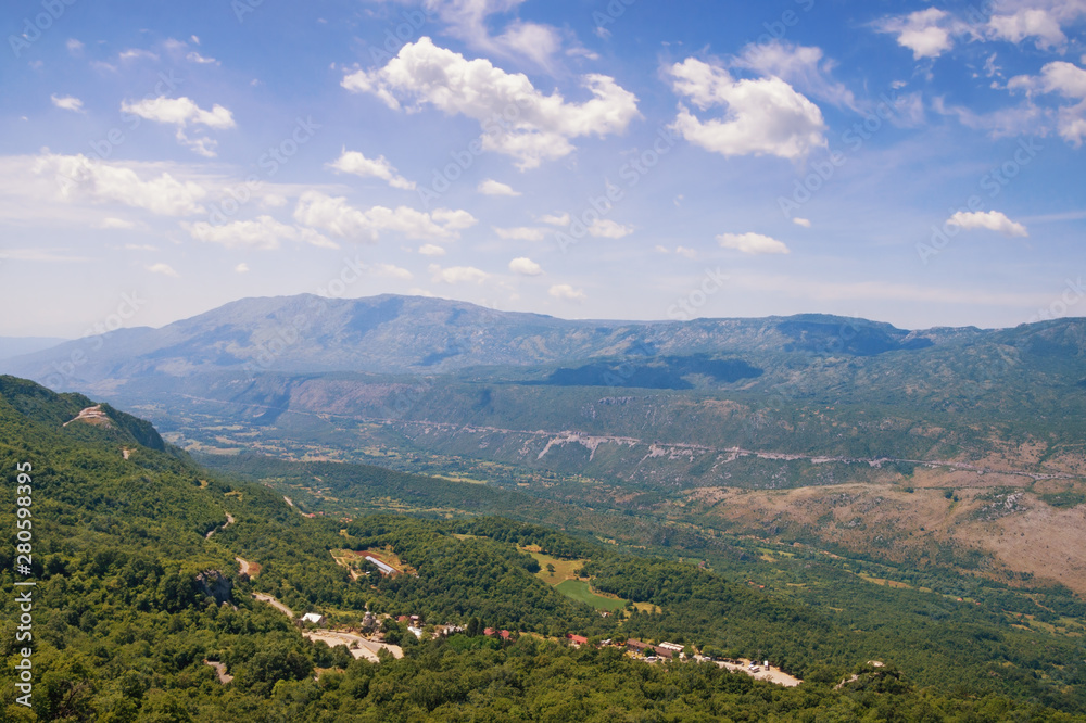 Beautiful mountain landscape on sunny summer day. Montenegro, Dinaric Alps, view of Bjelopavlici plain near Ostrog monastery