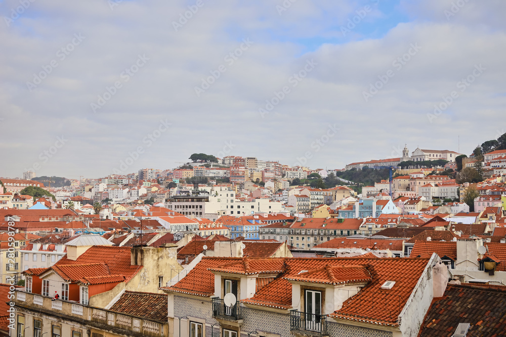 Lisbon Portugal - Beautiful panoramic view of the red roofs of houses in antique historical district Alfama and the Tagus River and bridge from Sao Jorge Castle