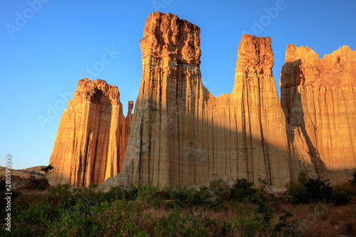 Earth Forest of Yuanmou in Yunnan Province  China - Exotic earth and sandstone formations glowing in the sunlight. Naturally formed pillars of rock and clay with unique erosion patterns. China Travel