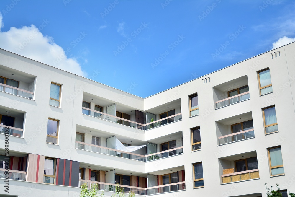 modern apartment building with blue sky and clouds