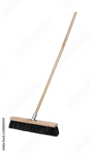 Broom with long wooden handle isolated on white background. Cleaning equipment for housework