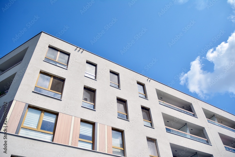 modern apartment building with blue sky and clouds modern apartment building with blue sky and clouds