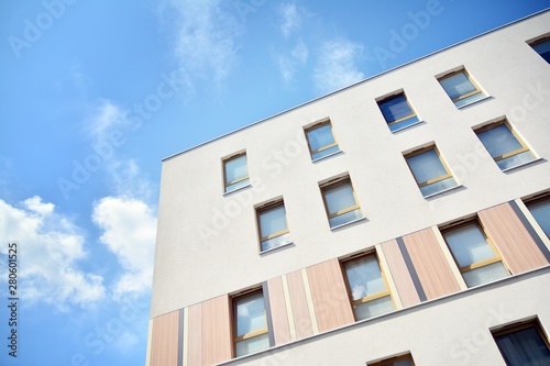 modern apartment building with blue sky and clouds