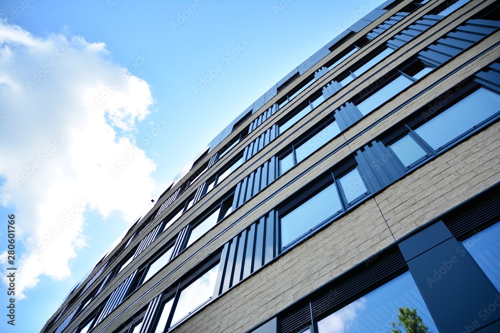 modern office building with blue sky and clouds