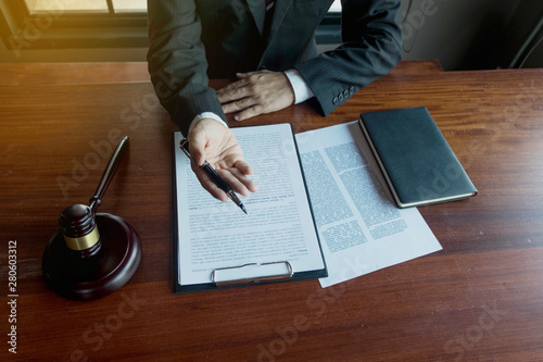 Lawyer present client with contract papers on the table in office. consultant lawyer, attorney, court judge, concept.