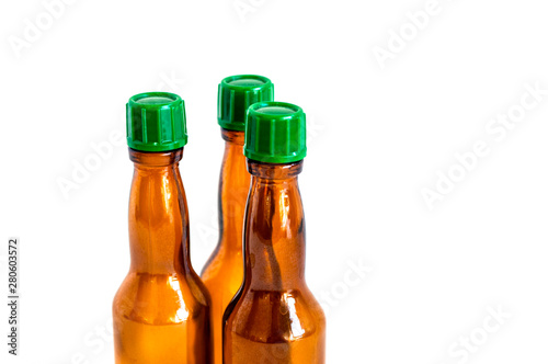 Close-up shoot of three small alcohol bottles brown colored