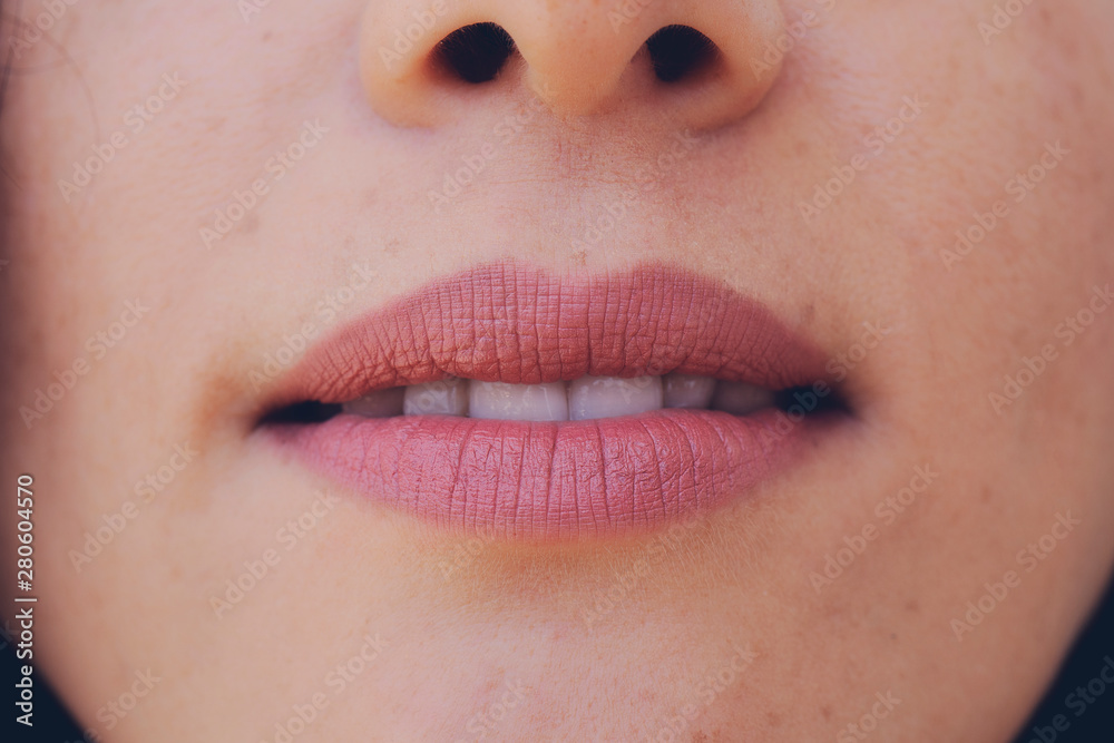 Fototapeta premium Perfect natural lip makeup. Close up macro photo with beautiful female mouth. Plump full lips. Close-up face detail. Perfect clean skin, light fresh lip make-up. Beautiful spa tender lip