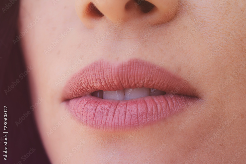 Obraz premium Sensual beautiful freckles woman mouth close up image against black background.