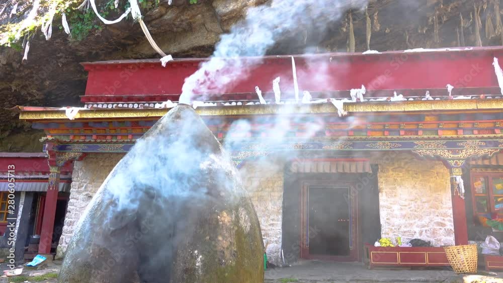CLOSE UP White smoke rolls out of a furnace burning in front of a small
