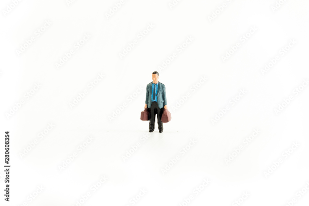 Iconic photo of a Businessman holding two bags, Miniature person with white isolated background Iconic photo of a Businessman holding two bags, Miniature person with white isolated background