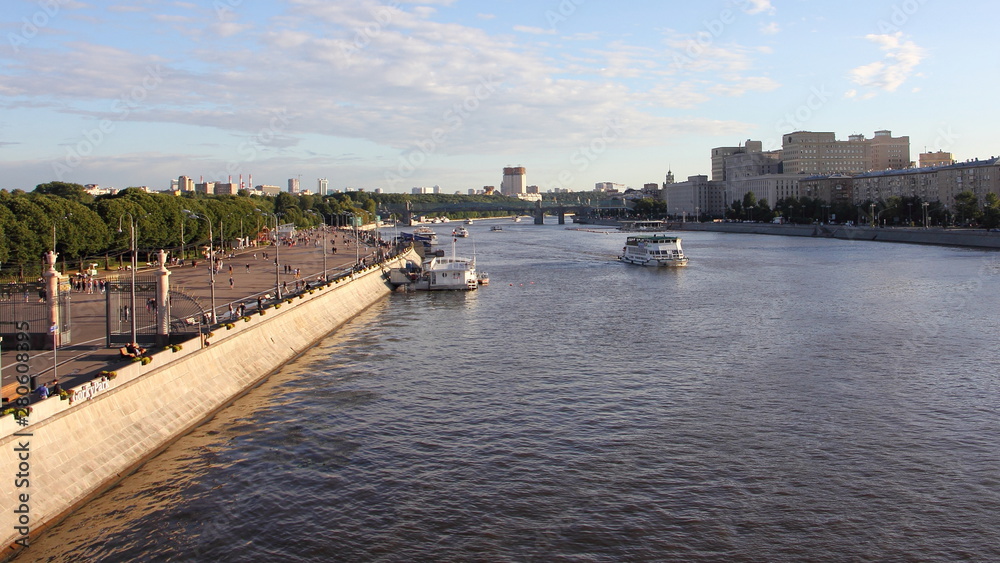 Top view of Pushkin embankment, St. Andrew's bridge in Gorky Park and the Moscow river with ships on a Sunny summer day against the blue sky