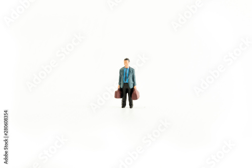 Iconic photo of a Businessman holding two bags, Miniature person with white isolated background