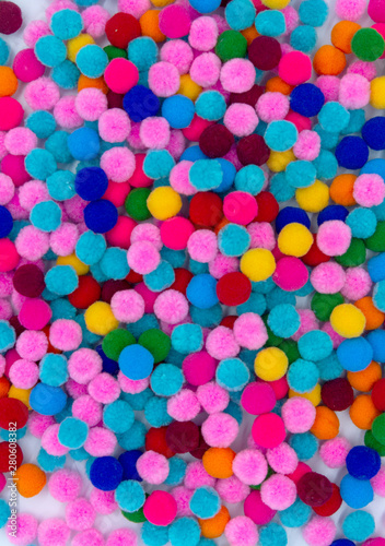 A colorful of Pom Pom background, top view colorful pom poms background.